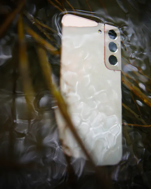 Smartphone submerged in water showing water damage risk